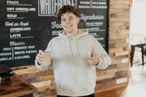 a man holding a coffee